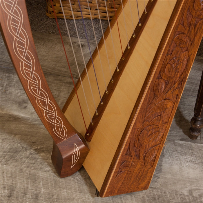 Roosebeck Heather Harp, Chelby Levers, 22 Strings, Celtic Thistle. Close-up of soundboard and base.